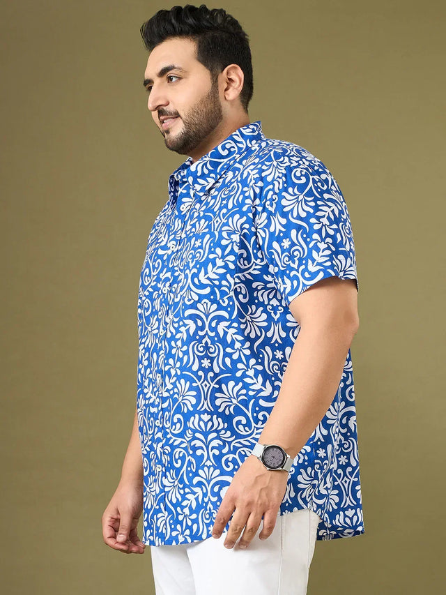 Plus size man in short-sleeve blue and white floral shirt with white pants