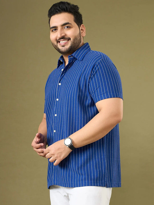 Plus size man wearing blue vertical striped short sleeve shirt and white pants