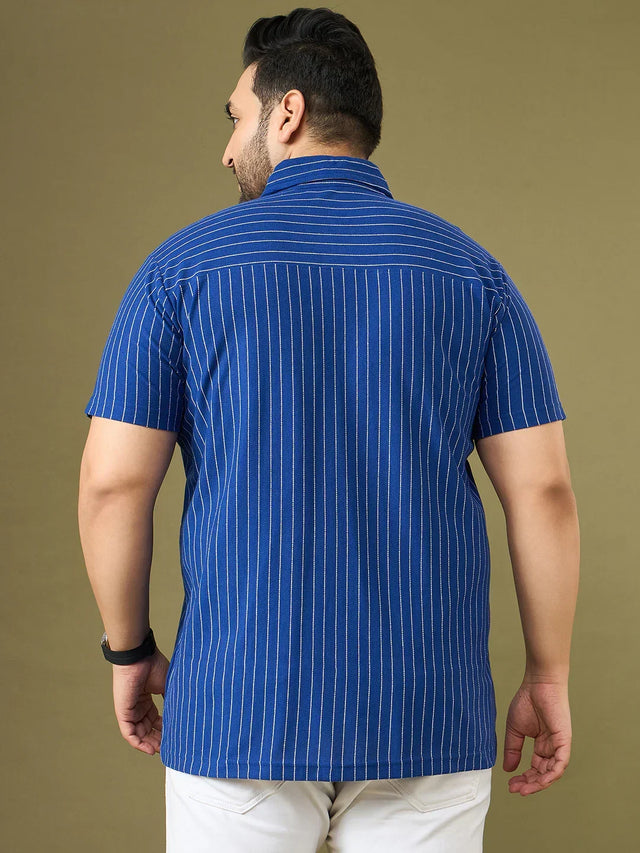 Back view of a man wearing a blue vertical striped short sleeve shirt, plus size fit