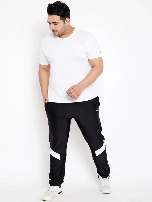 Plus size man in white t-shirt and black joggers with white stripes, casual fashion style