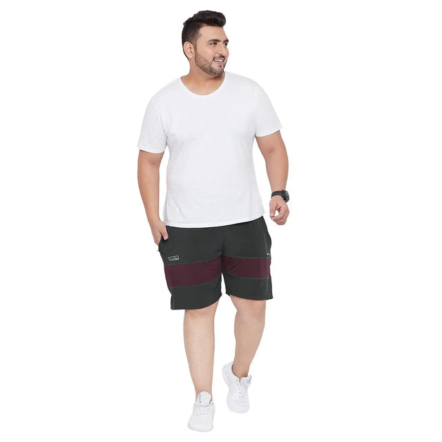 Plus size man wearing white t-shirt and black shorts with maroon stripe, casual style