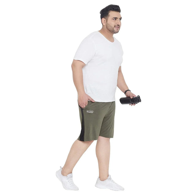 Plus size man in a white t-shirt and olive green shorts holding a black water bottle