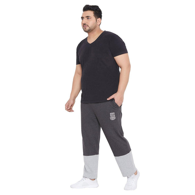 Plus size man wearing black t-shirt and grey colorblock joggers, casual outfit