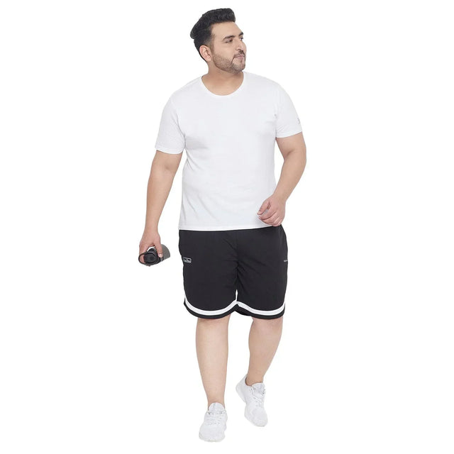 Plus size man in white t-shirt and black sports shorts holding a dumbbell, athletic wear