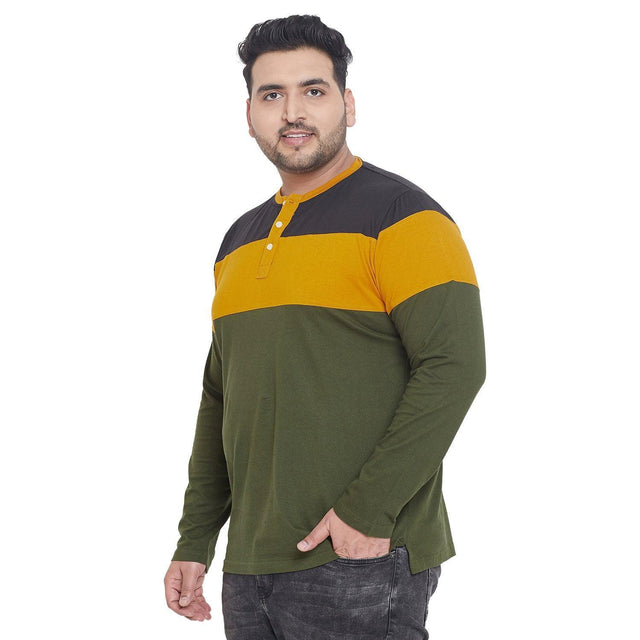 Plus size man wearing long sleeve colorblock henley t-shirt in olive, mustard, and black