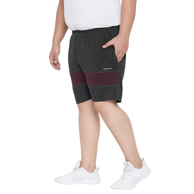 Men's plus size black shorts with maroon panels, elastic waist, model in white tee