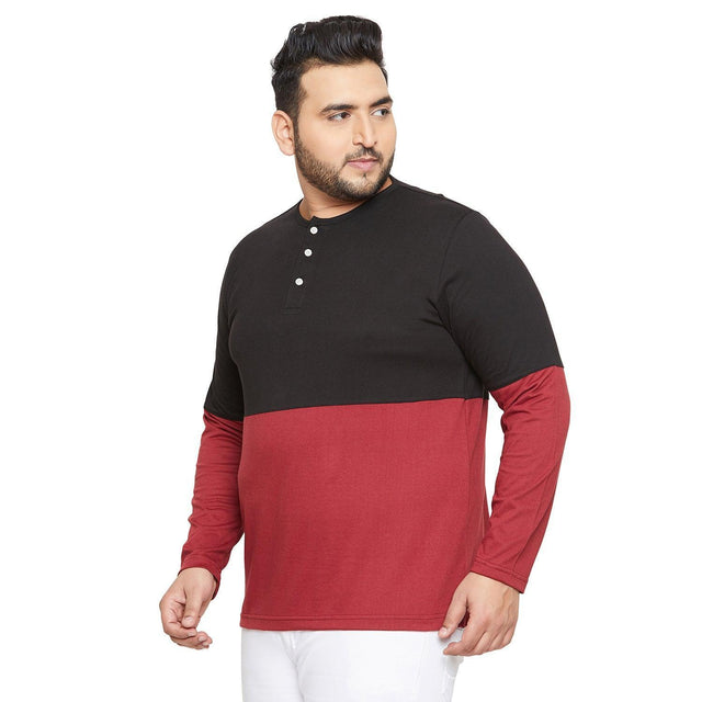 Plus size man wearing a colorblock black and maroon long sleeve henley t-shirt