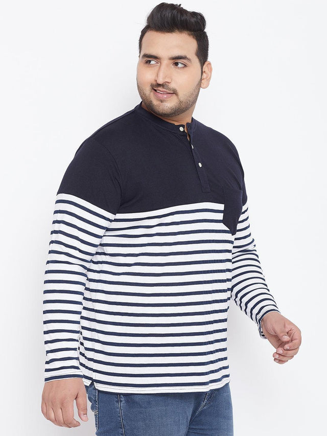 Plus size man wearing navy and white striped long sleeve henley t-shirt with blue jeans