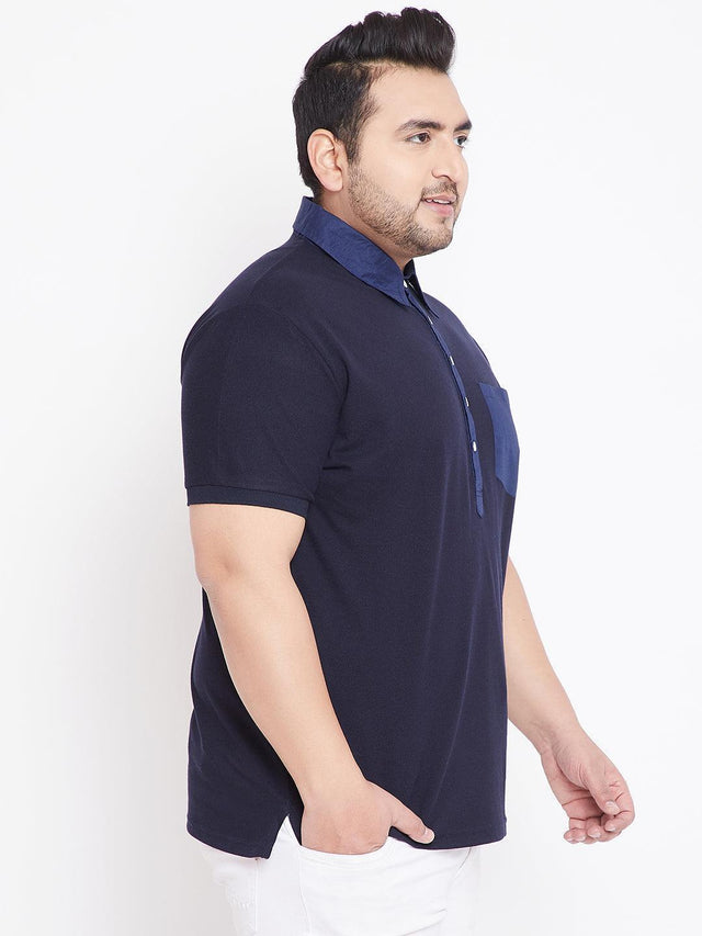 Plus size man in navy blue short sleeve polo shirt with contrasting collar and pocket