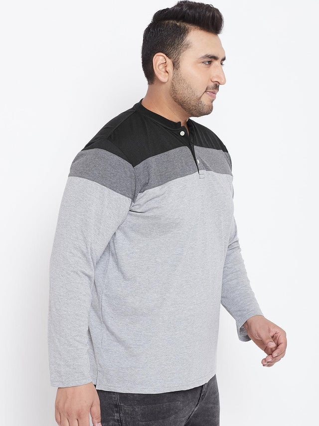 Plus size man wearing a grey and black colorblock long sleeve t-shirt