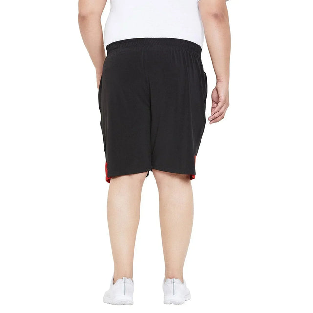 Back view of plus size man wearing black elastic waist shorts with red side accents