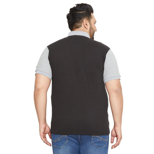 Plus size man wearing black and grey polo t-shirt with blue jeans, shown from the back
