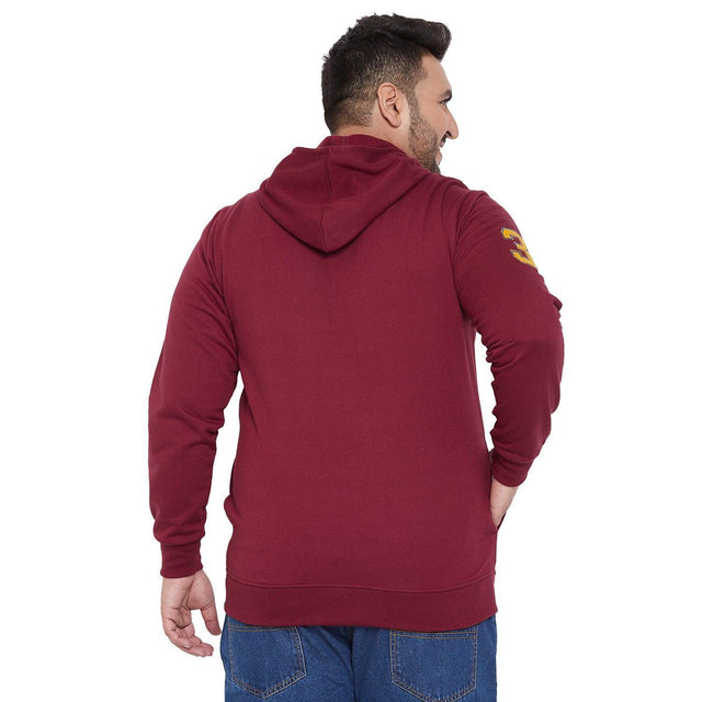 Plus size man in maroon hoodie and blue jeans, back view, casual fashion