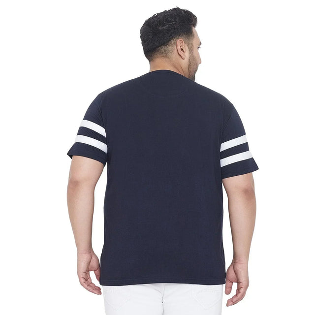 Back view of a man wearing a navy blue plus size t-shirt with white sleeve stripes