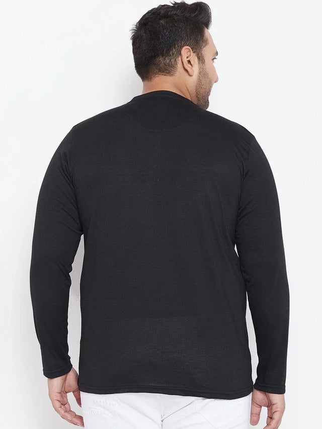Back view of man wearing black long sleeve plus size t-shirt and white pants
