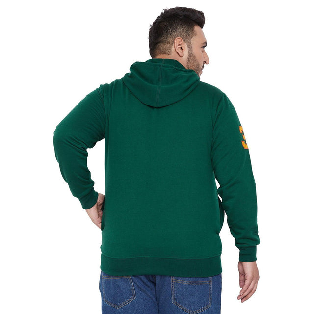 Plus size man wearing green hoodie and blue jeans, back view, casual men's clothing