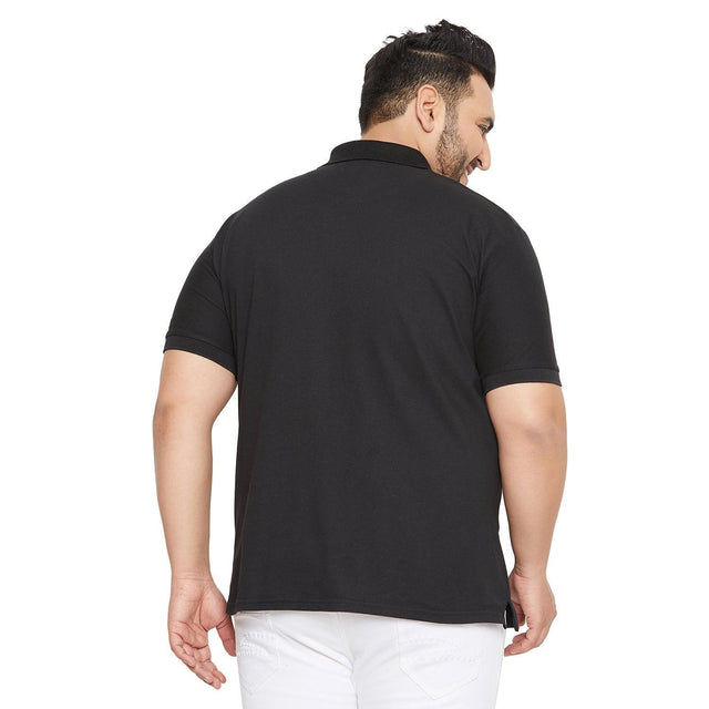 Back view of a man wearing a black plus size polo t-shirt and white jeans