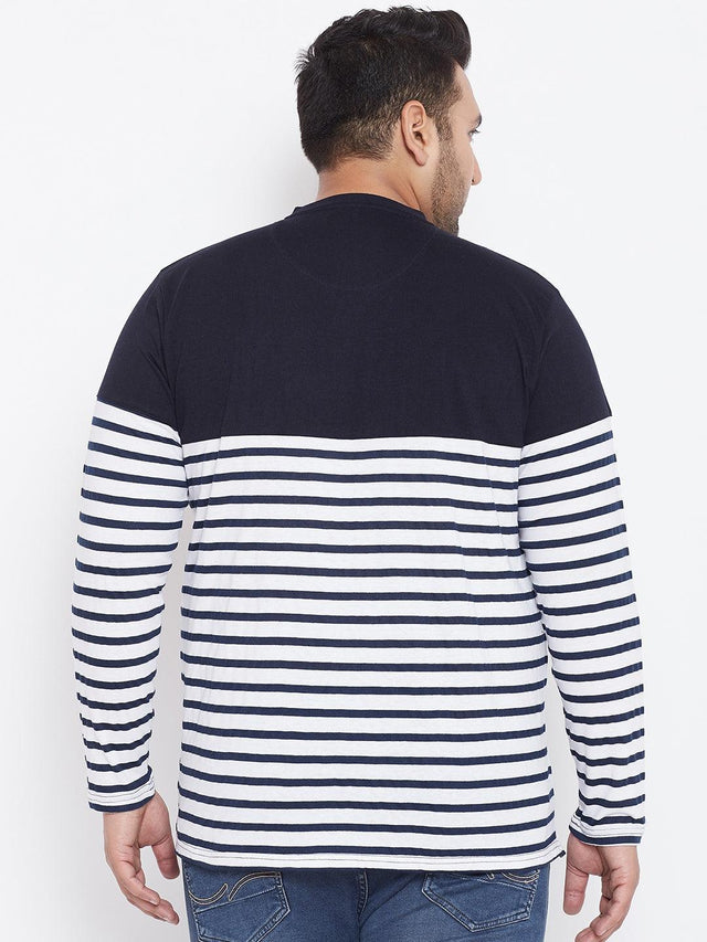 Back view of plus size man wearing navy blue and white striped long sleeve t-shirt and jeans