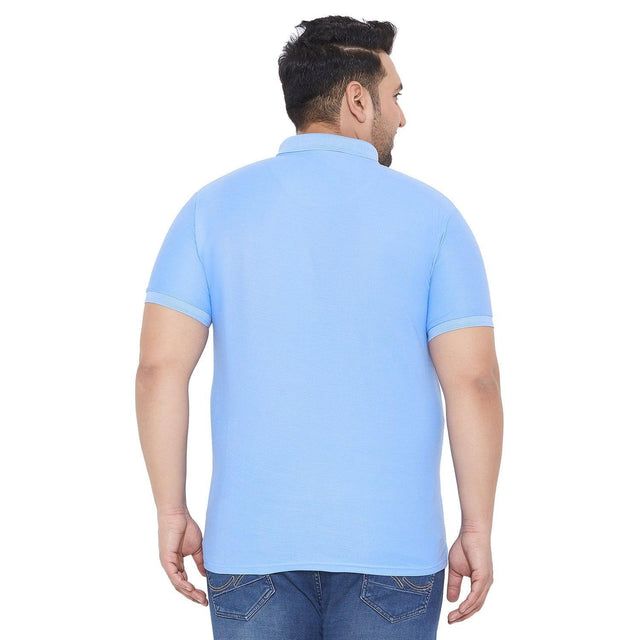 Back view of a man wearing a light blue plus size polo t-shirt and blue jeans