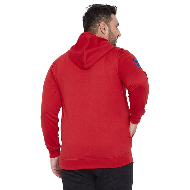 Back view of plus size man wearing red hooded sweatshirt and black jeans