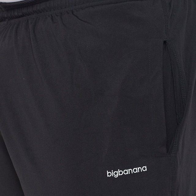 Black men's plus size joggers with side pocket and elastic waist, logo detail shown