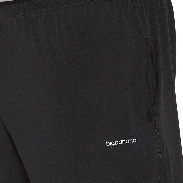 Close-up of black plus size men's joggers with elastic waistband and side pocket