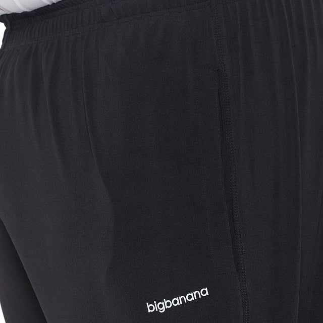 Close-up of black plus size men's joggers with elastic waistband and side pocket