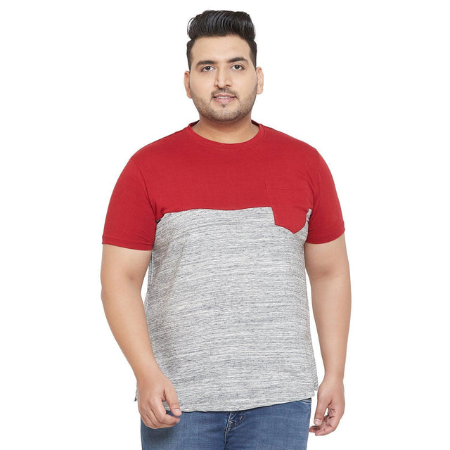 Plus size man wearing red and grey colorblock t-shirt with chest pocket and blue jeans
