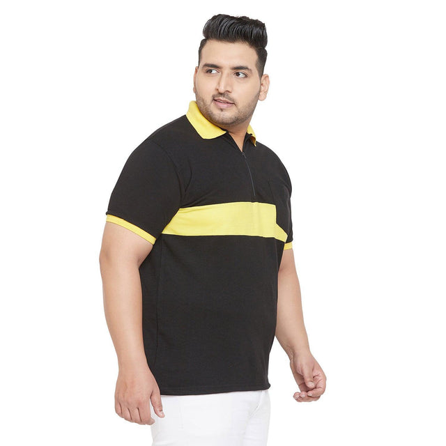Plus size man wearing a black polo t-shirt with yellow stripe and collar, white background
