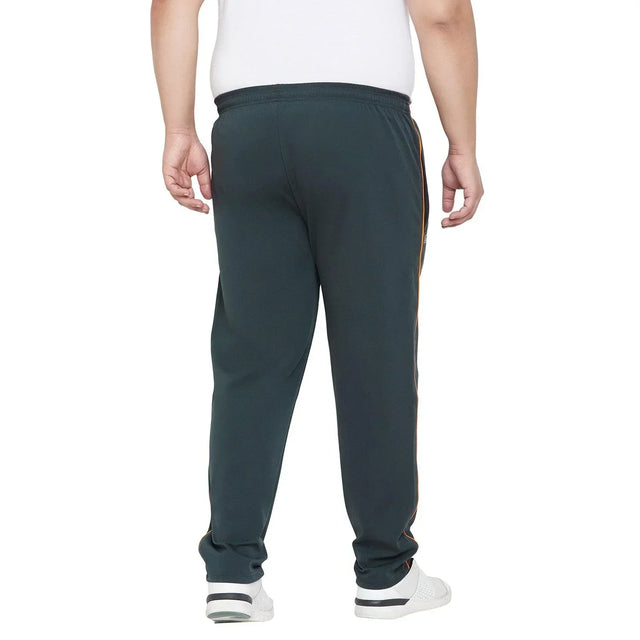 Back view of a man wearing black plus size joggers with side stripes and white sneakers
