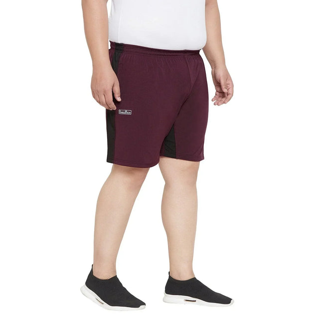 Men's plus size maroon athletic shorts with black side panels, elastic waistband, and logo patch
