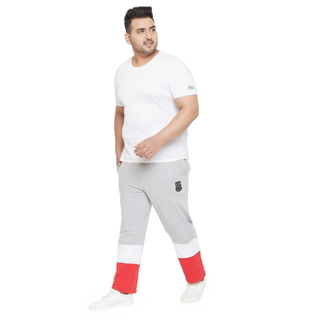 Plus size man in white t-shirt and grey joggers with red and white color block cuffs